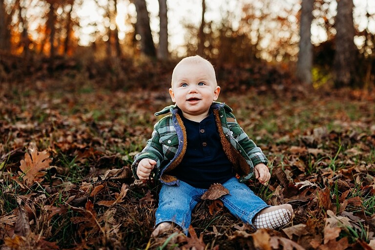 Family holding their baby during a session in High Hill Missouri.
Parents kissing their smiling little boy in warm natural light.
Baby laughing while sitting with his parents on a country path.
Family walking together through a grassy field.
Close-up of baby boy smiling during his milestone session.