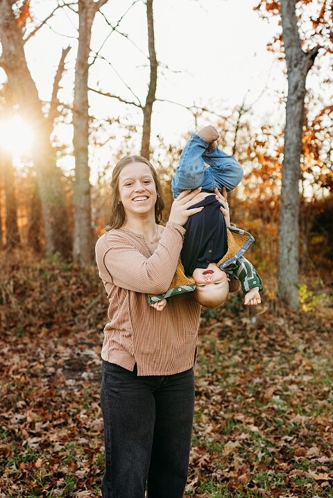 Family holding their baby during a session in High Hill Missouri.
Parents kissing their smiling little boy in warm natural light.
Baby laughing while sitting with his parents on a country path.
Family walking together through a grassy field.
Close-up of baby boy smiling during his milestone session.