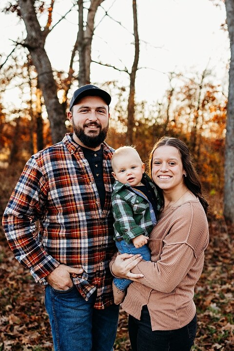 Family holding their baby during a session in High Hill Missouri.
Parents kissing their smiling little boy in warm natural light.
Baby laughing while sitting with his parents on a country path.
Family walking together through a grassy field.
Close-up of baby boy smiling during his milestone session.